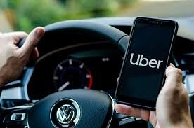 This-image-shows-a-phone-showing-uber-held-by-a-male-hand