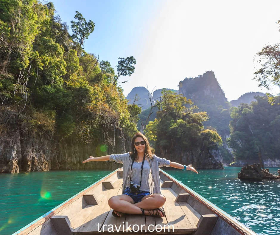 A lady capturing vacation memories with a beautiful background of nature.